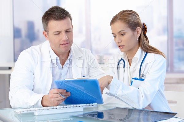 Young doctors discussing diagnosis in office Stock photo © nyul