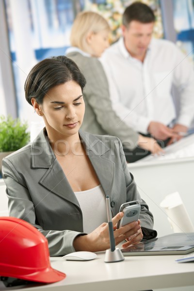 Businesswoman in office using smartphone Stock photo © nyul