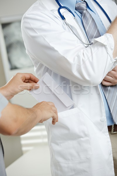Patient bribing doctor Stock photo © nyul