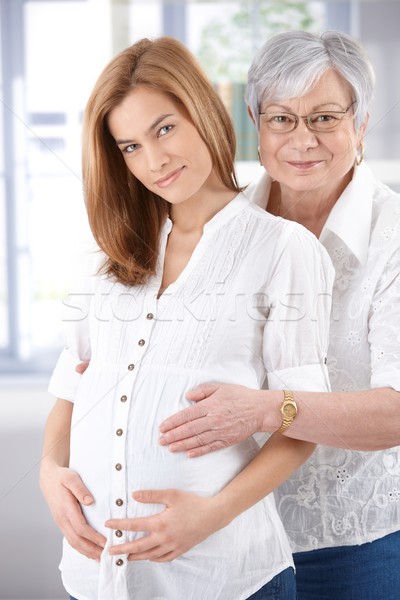 Stock photo: Expectant woman and senior mother smiling�