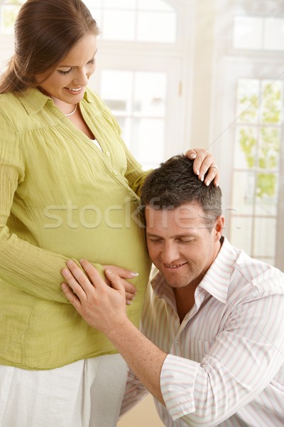 Dad listening to baby in belly Stock photo © nyul