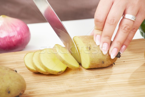 Female hand chopping potatoe Stock photo © nyul
