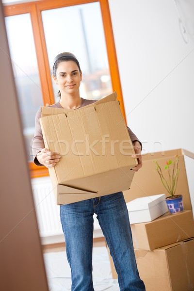 Young woman lifting cardboard box Stock photo © nyul