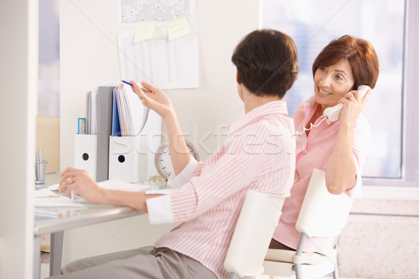 Female office workers sitting at desk Stock photo © nyul
