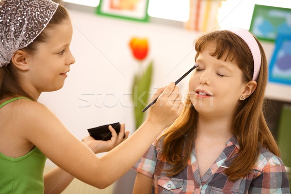 Young girl putting makeup on friend Stock photo © nyul