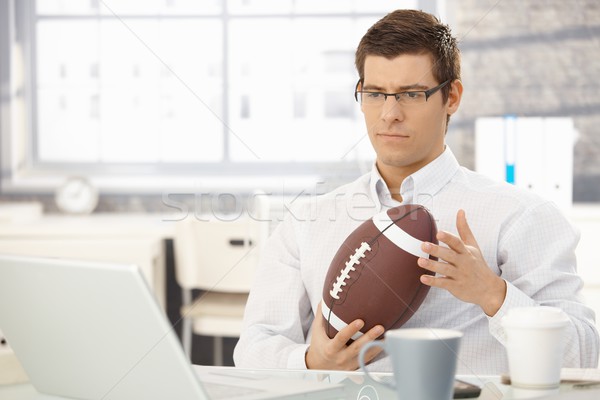 Troubled businessman thinking holding football Stock photo © nyul