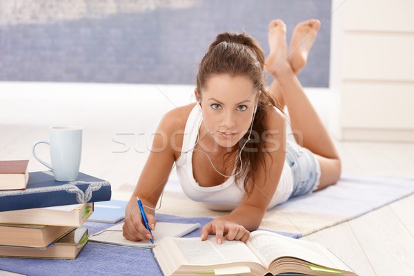 Pretty girl writing homework laying on floor Stock photo © nyul