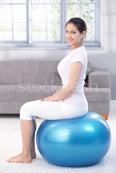 Attractive female sitting on fit ball Stock photo © nyul