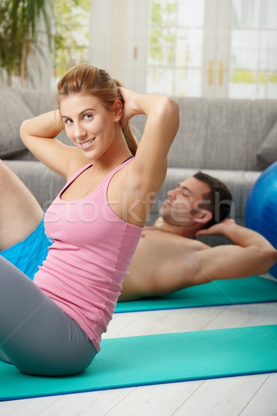 Stock photo: Couple doing abdominal crunch