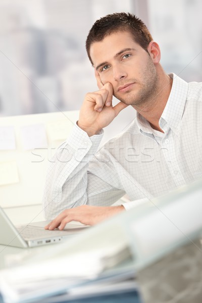 Troubled businessman sitting at desk Stock photo © nyul