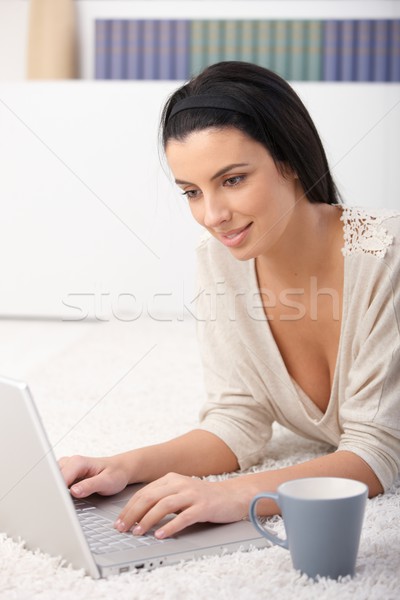 Woman using computer at home Stock photo © nyul