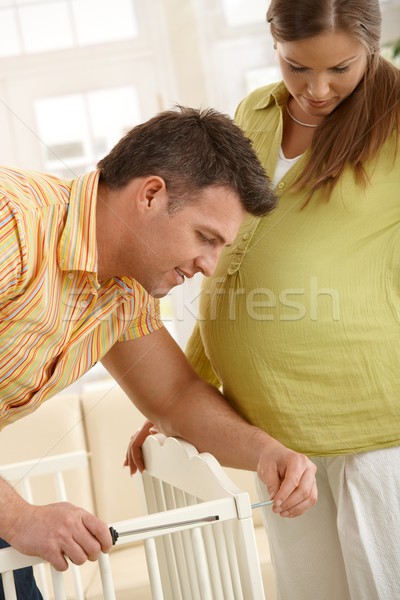 Stock photo: Couple fixing baby bed 