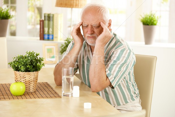 Idős férfi fejfájás ül asztal rossz Stock fotó © nyul