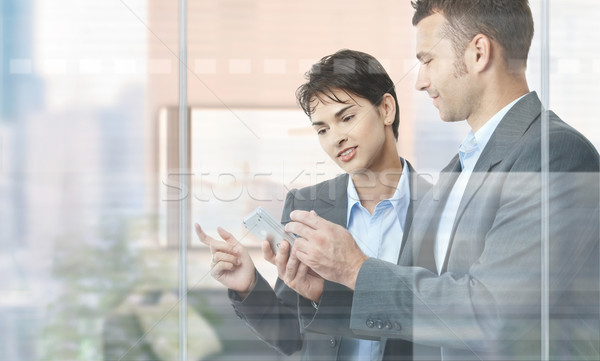 üzletemberek mobil kettő áll modern iroda Stock fotó © nyul