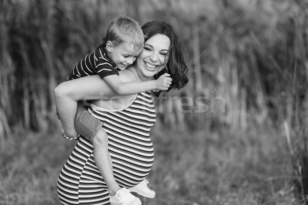 Child sitting on the shoulders of his mather. Stock photo © O_Lypa