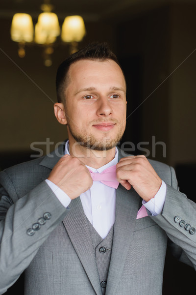 Young man dressing up for wedding celebration. Stock photo © O_Lypa