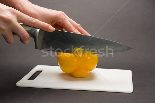 Stock photo: Slicing yellow pepper on chopping board