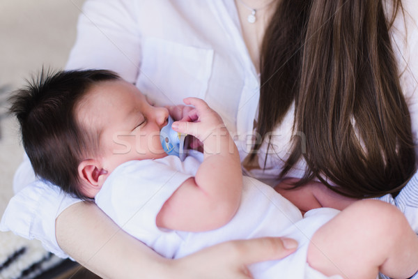 Young mother holding her newborn child Stock photo © O_Lypa