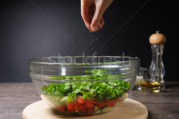 Hand adding salt Stock photo © O_Lypa