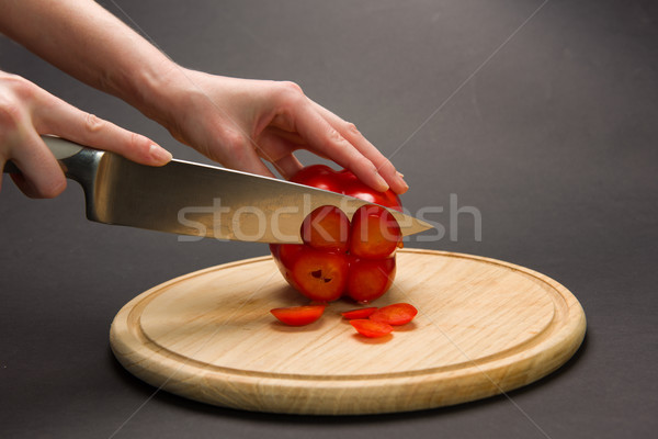 Woman slices red pepper on chopping board Stock photo © O_Lypa