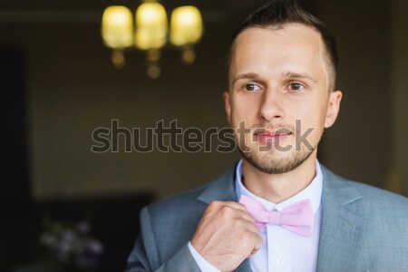 Man adjusts his bow tie Stock photo © O_Lypa