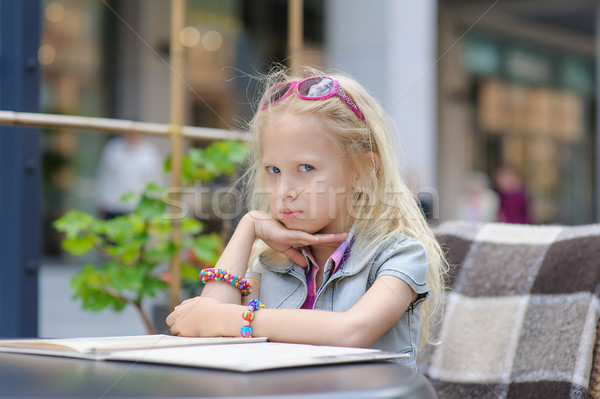 Pretty child reading menu in the cafe Stock photo © O_Lypa