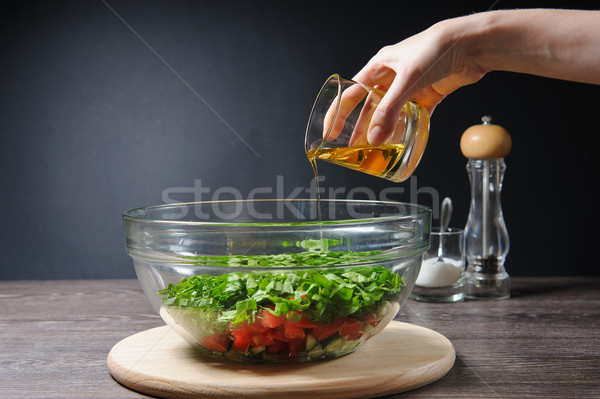 Woman added to salads olive oil Stock photo © O_Lypa
