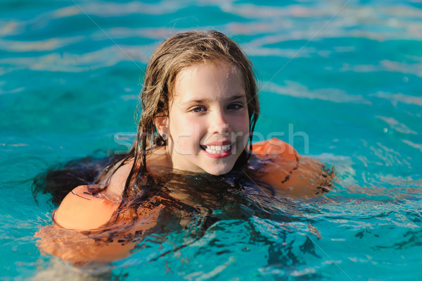 Child with water wings in swimming pool Stock photo © O_Lypa