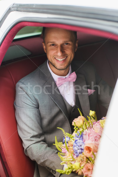 Groom with bouquet in the wedding car Stock photo © O_Lypa