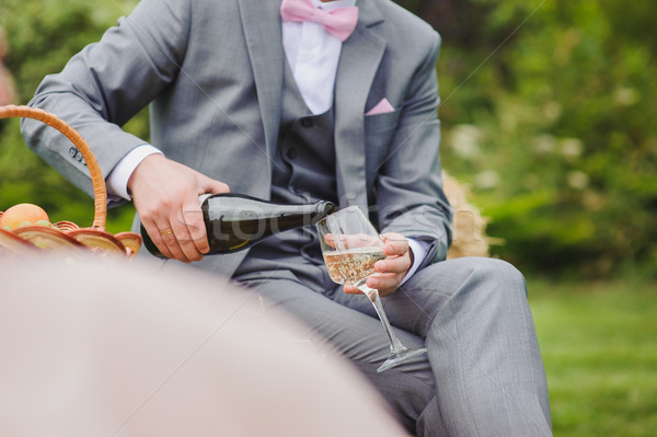 Man pours himself a glass of wine Stock photo © O_Lypa