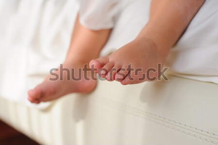 Children's bare feet,  sitting on bed Stock photo © O_Lypa