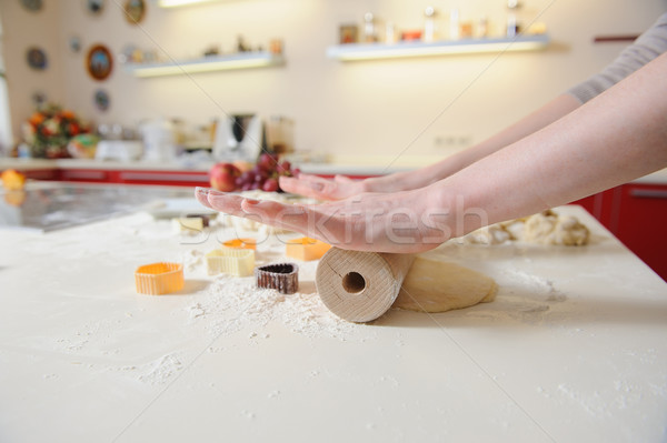 Closeup of woman hand with rolling baking cookies Stock photo © O_Lypa