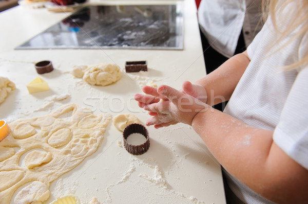 Stock photo: Hands of  child knead dough 