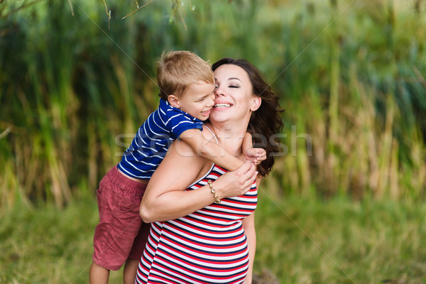 Boy kissing his pregnant mother. Stock photo © O_Lypa