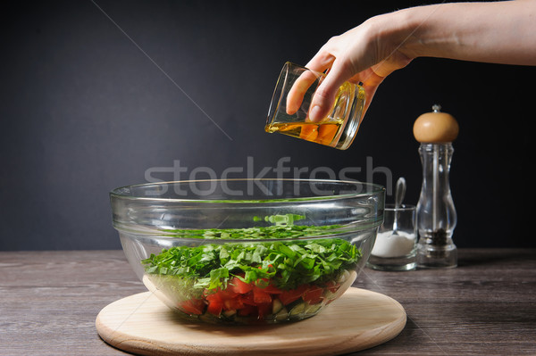 Woman added to salads olive oil Stock photo © O_Lypa