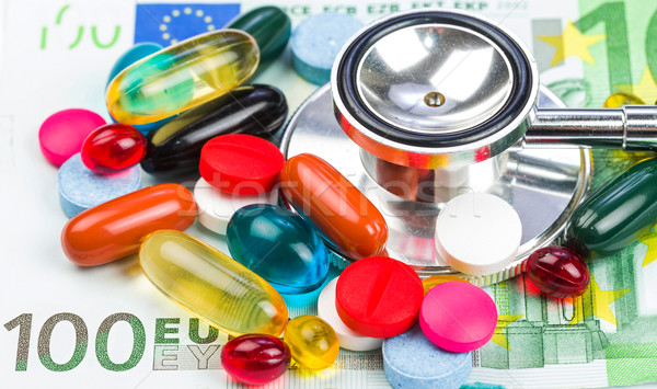 Tabletták pénz közelkép fotó színes sztetoszkóp Stock fotó © Obencem