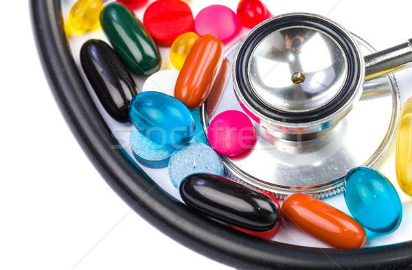 Színes tabletták közelkép fotó sztetoszkóp izolált Stock fotó © Obencem