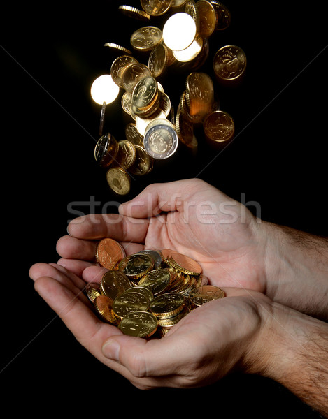 Człowiek ręce pełny ceny deszcz monet Zdjęcia stock © ocusfocus