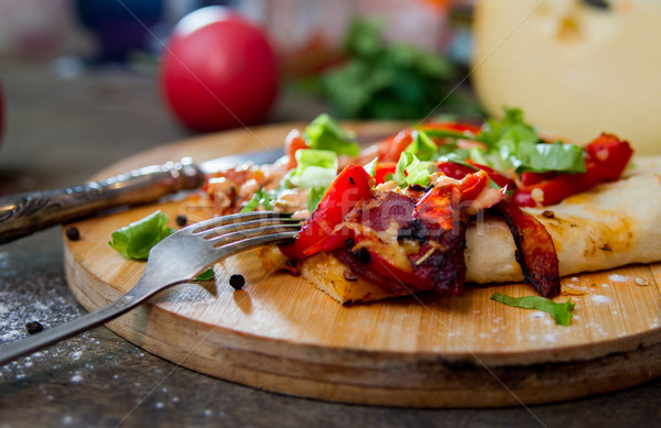 slice of pizza with peppers, bacon and herbs on a wooden board Stock photo © oei1