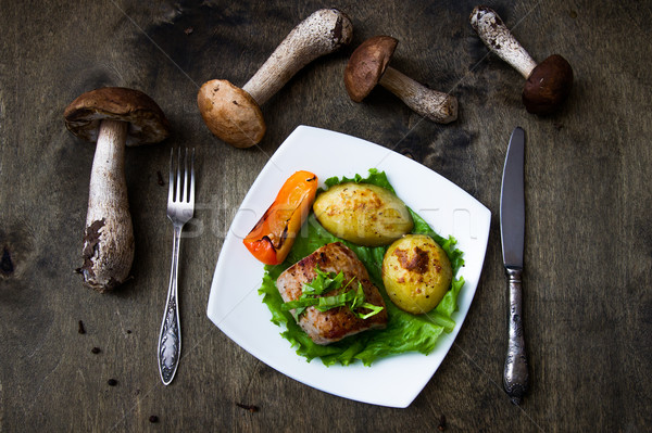 Pork steak with baked potato and mushroom sauce Stock photo © oei1