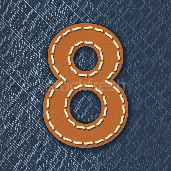 number 8 made from leather on jeans background