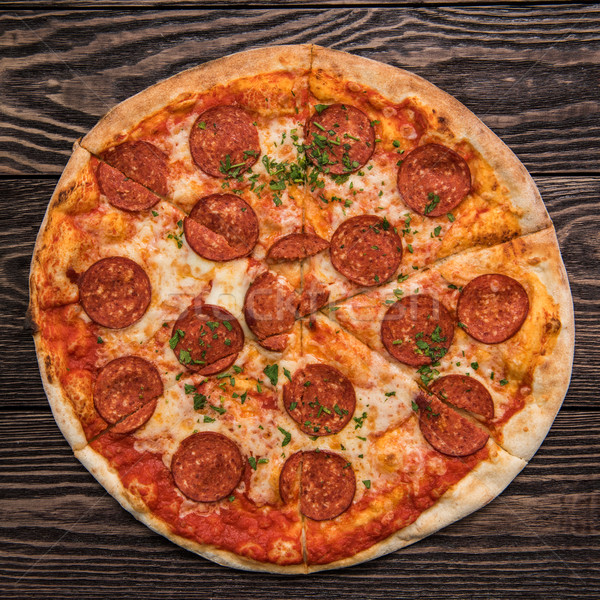 Lezzetli pepperoni pizza ahşap masa restoran tablo Stok fotoğraf © olira