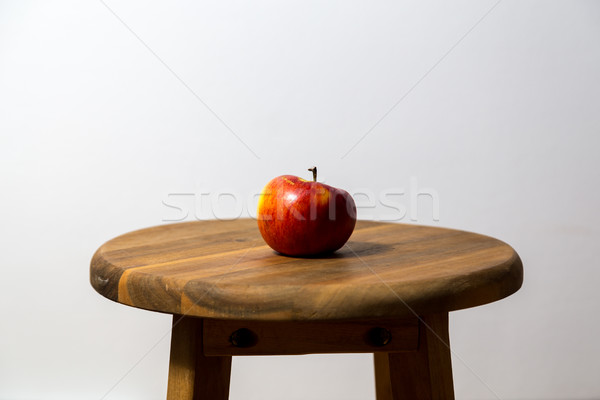 Single apple on wooden stool Stock photo © oliverfoerstner