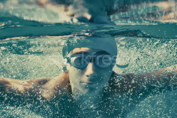Young boy swimming underwater in a pool Stock photo © orla