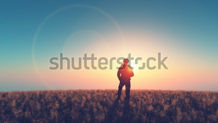 Adam bakmak güneş alan kuru çim Stok fotoğraf © orla