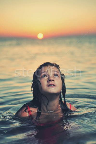Joven vestido rojo pie mar puesta de sol agua Foto stock © orla