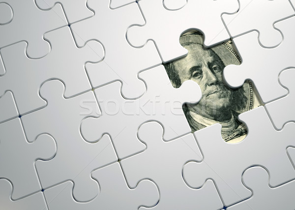 Puzzle pieces on dollar  Stock photo © orla