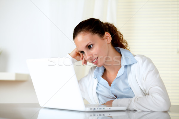 Encantador mulher jovem olhando pensativo laptop tela Foto stock © pablocalvog