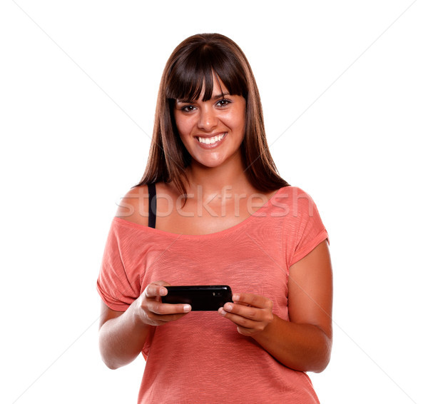 Joli jeune femme regarder mobiles téléphone portable blanche [[stock_photo]] © pablocalvog