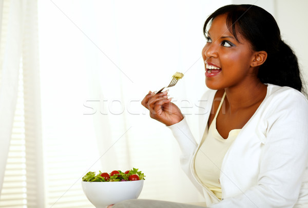 Lady looking to right and eating a green salad Stock photo © pablocalvog